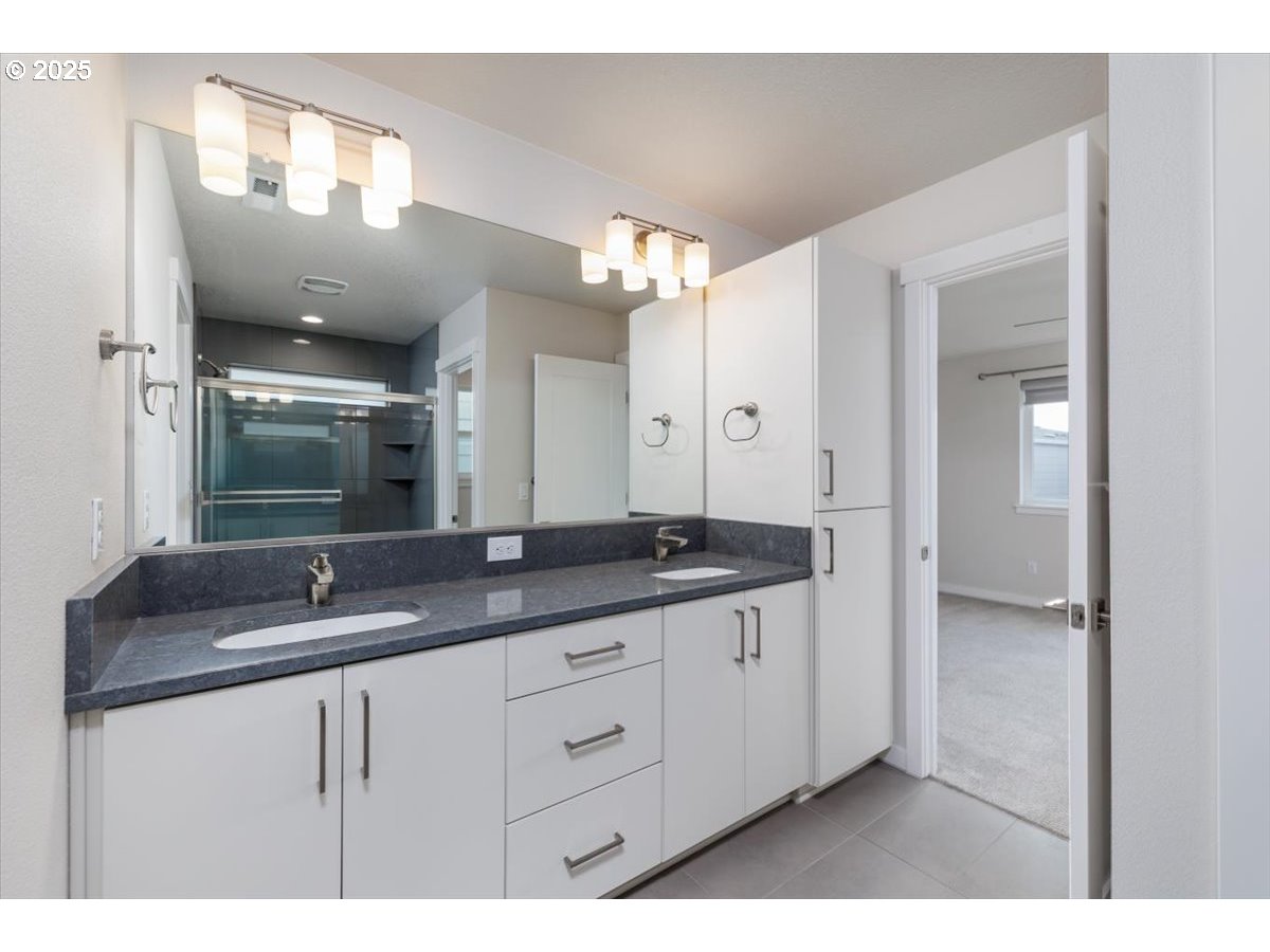 961 Southwest Stellar Terrace Beaverton, OR 97005 - Photo 16 of 25 a bathroom with a granite countertop sink and a mirror