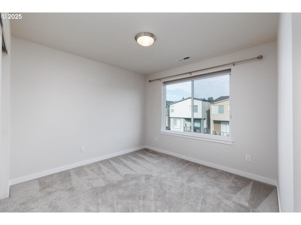 961 Southwest Stellar Terrace Beaverton, OR 97005 - Photo 21 of 25 a view of an empty room with a window