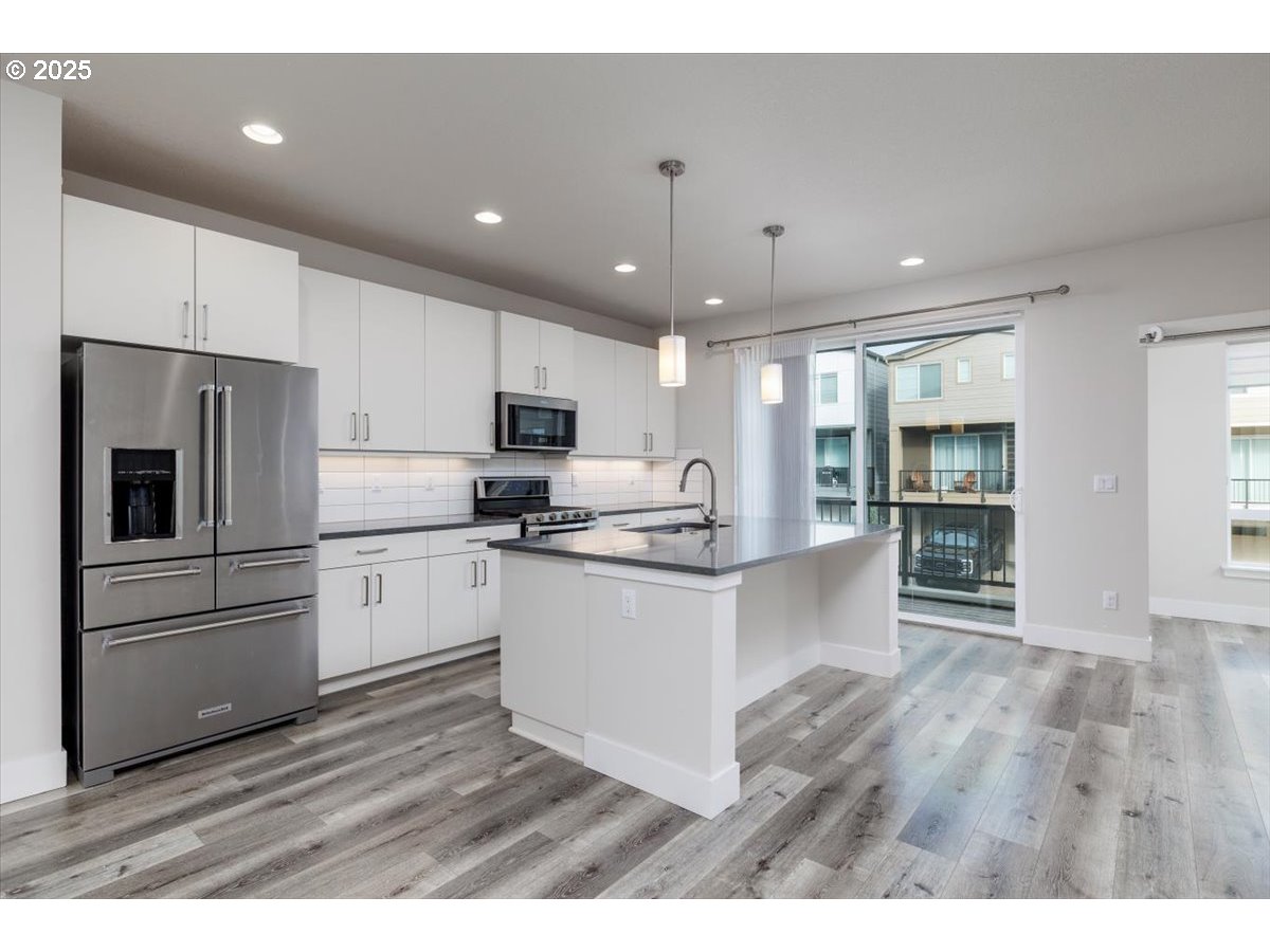 961 Southwest Stellar Terrace Beaverton, OR 97005 - Photo 9 of 25 a kitchen with stainless steel appliances a refrigerator sink and microwave