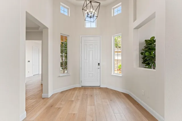 a view of a room with wooden floor and windows