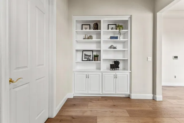 a view of a workspace with furniture and a window