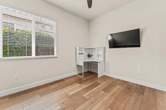 a workspace with wooden floor and furniture