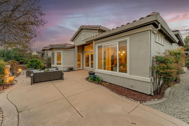 a front view of a house with fountain in front of it