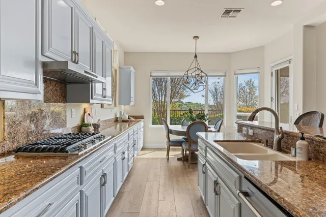 a dining room with furniture a chandelier and a rug