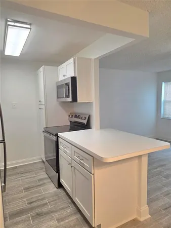 a kitchen with stainless steel appliances a white stove top oven and sink