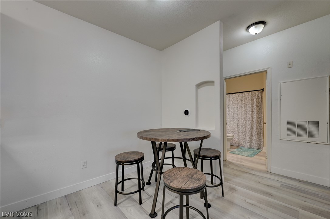 4730 East Craig Road, Unit 1155 Las Vegas, NV 89115 - Photo 9 of 41 Pale plank flooring extends through a cozy breakfast nook with a decorative wall niche.