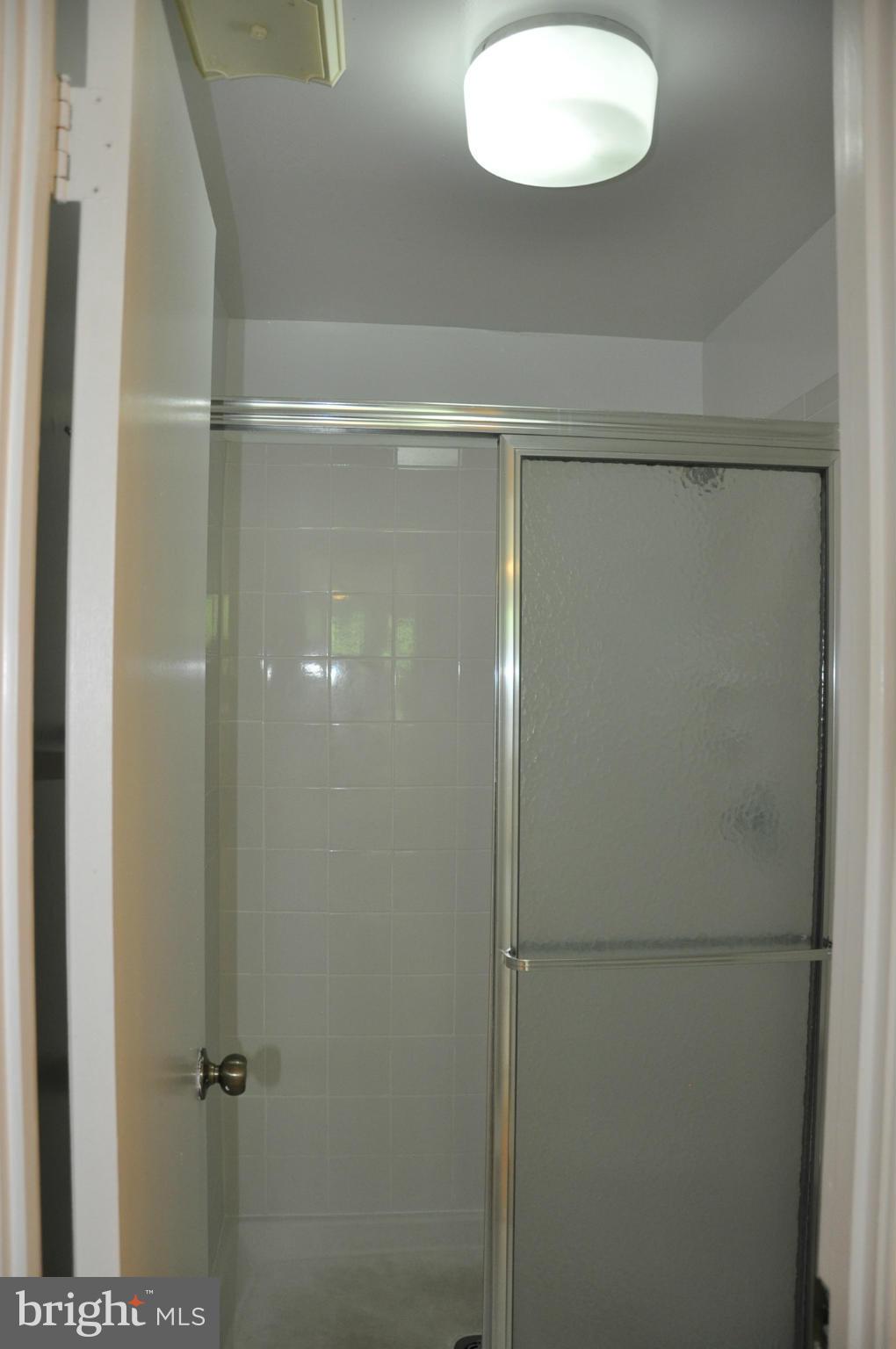 12 Starlight Court Potomac, MD 20854 - Photo 13 of 19 a bathroom with a glass shower door