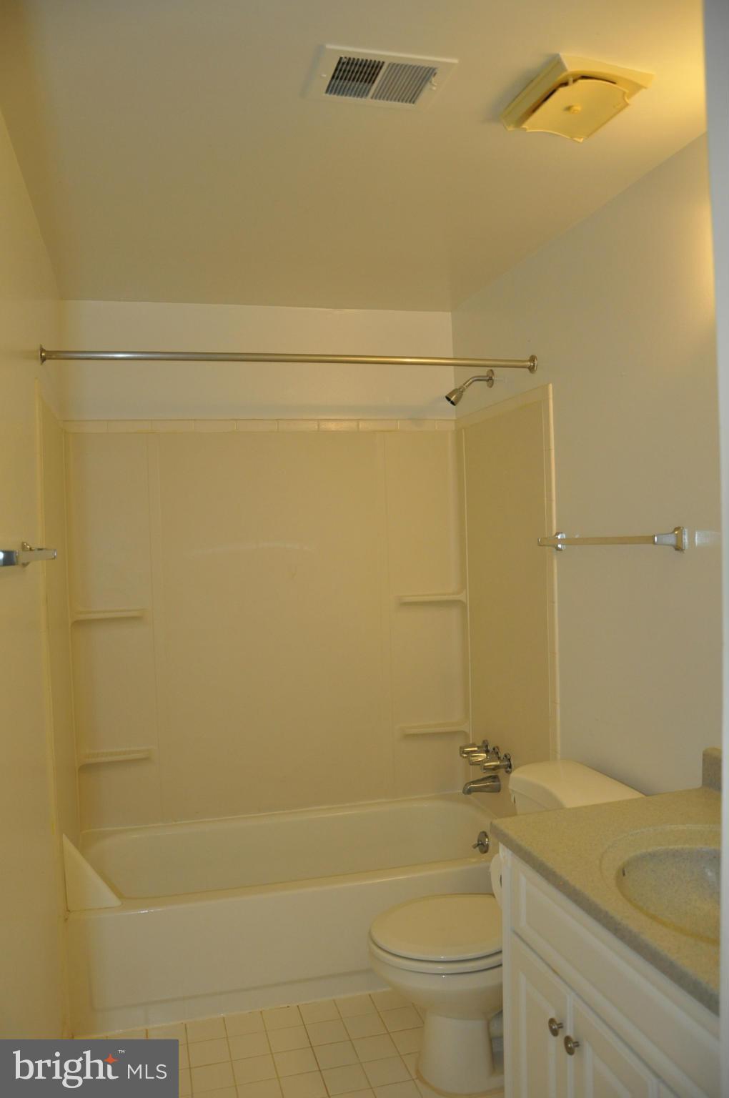 12 Starlight Court Potomac, MD 20854 - Photo 16 of 19 a bathroom with a granite countertop bathtub shower sink vanity and toilet