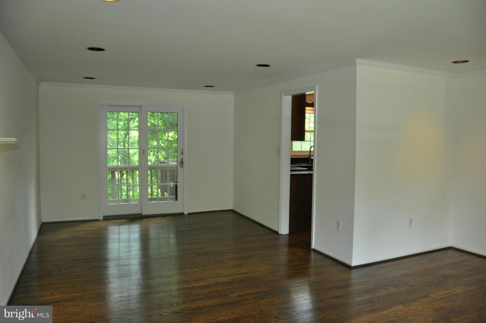12 Starlight Court Potomac, MD 20854 - Photo 6 of 19 a view of an empty room with wooden floor and a window