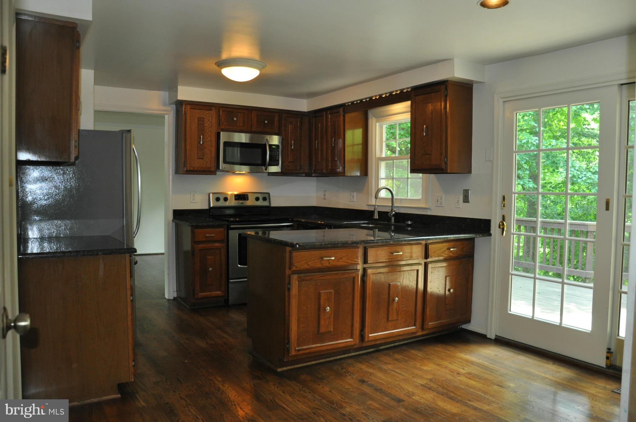 12 Starlight Court Potomac, MD 20854 - Photo 7 of 19 a kitchen with stainless steel appliances granite countertop a stove a sink and a microwave
