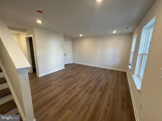 wooden floor in an empty room with a mirror