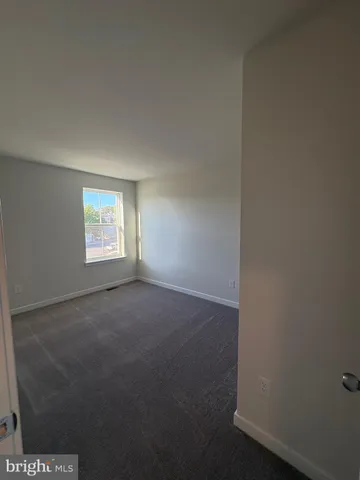 a view of an empty room and a window