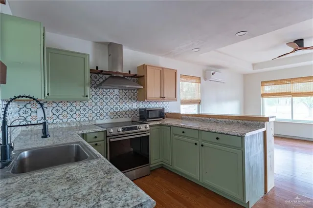 a kitchen with granite countertop a sink stove and cabinets