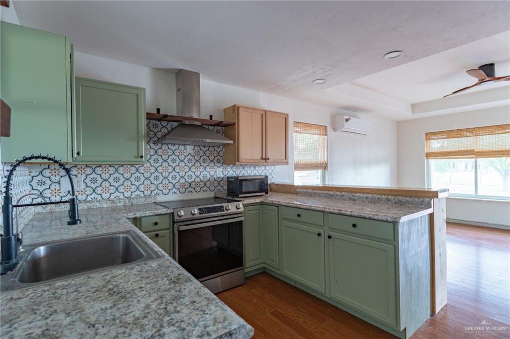 15002 Davis Road Edcouch, TX 78538 - Photo 12 of 33 a kitchen with granite countertop a sink stove and cabinets