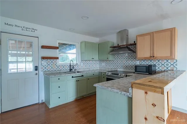 a kitchen with a sink stove and cabinets