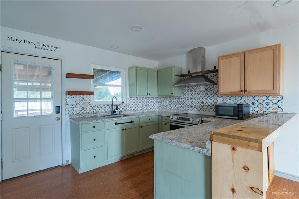 15002 Davis Road Edcouch, TX 78538 - Photo 10 of 33 a kitchen with a sink stove and cabinets