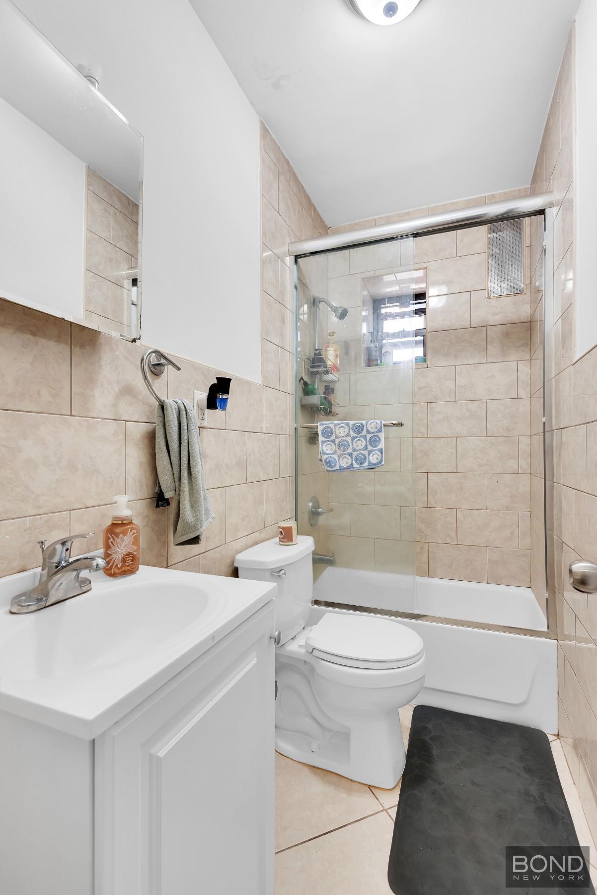 41-11 28th Avenue, Unit 1 Queens, NY 11103 - Photo 4 of 9 a bathroom with a sink toilet and shower