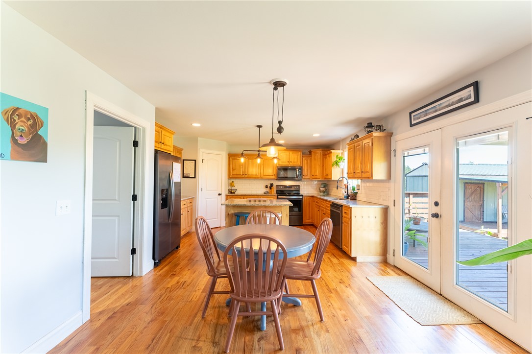 696 Mt Olivet Road Six Mile, SC 29682 - Photo 6 of 35 This spacious kitchen offers ample cabinetry, modern appliances, and convenient outdoor access.