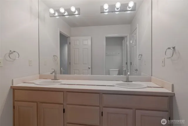 a bathroom with a sink vanity and a mirror