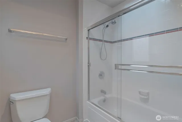 a bathroom with a shower and a toilet