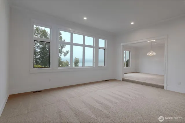 an empty room with windows and view of an empty room