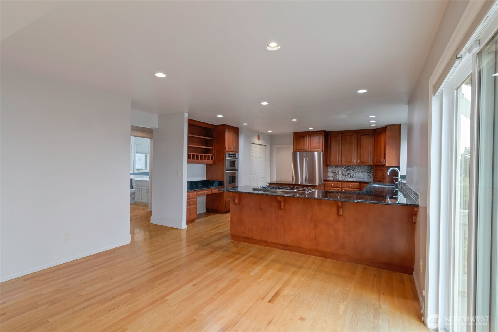 4131 205th Avenue Southeast Sammamish, WA 98075 - Photo 7 of 20 a view of kitchen with kitchen island wooden floor center island and stainless steel appliances
