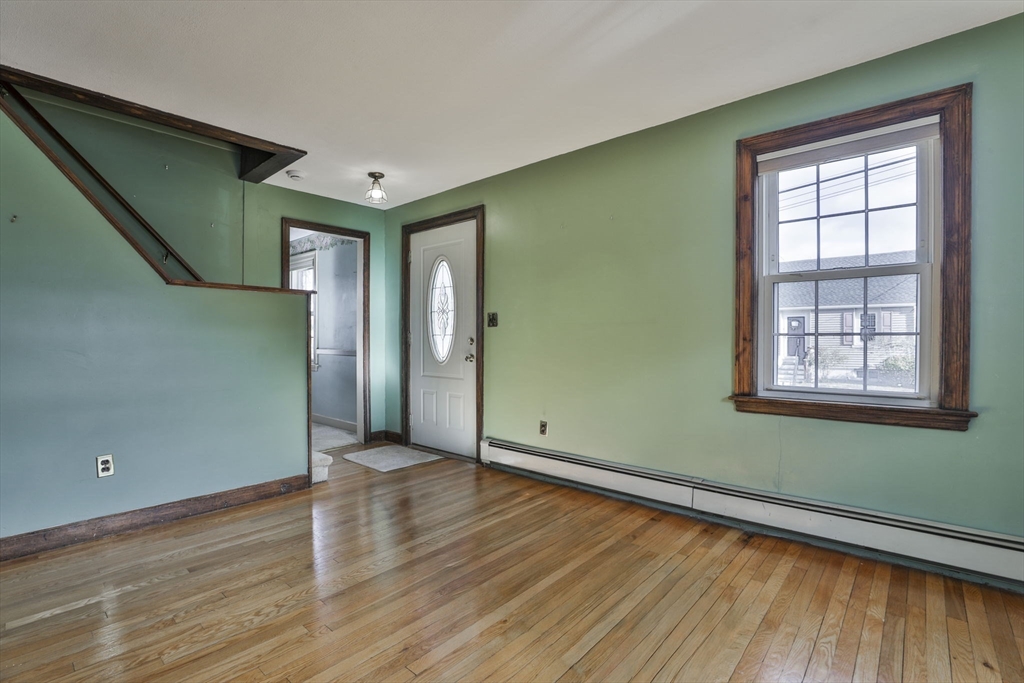 3 Veterans Lane Stoneham, MA 02180 - Photo 13 of 41 an empty room with wooden floor and windows