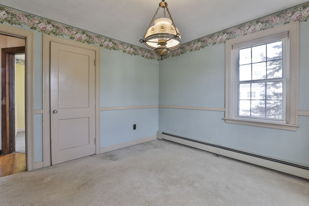3 Veterans Lane Stoneham, MA 02180 - Photo 17 of 41 en empty room with windows and chandelier