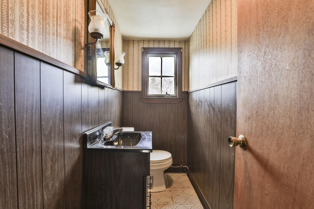 3 Veterans Lane Stoneham, MA 02180 - Photo 27 of 41 a bathroom with a granite countertop sink toilet and shower curtains