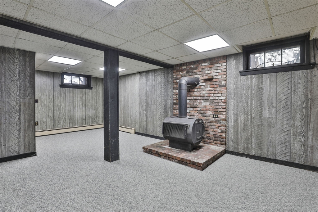 3 Veterans Lane Stoneham, MA 02180 - Photo 29 of 41 a living room with furniture a window and a fireplace