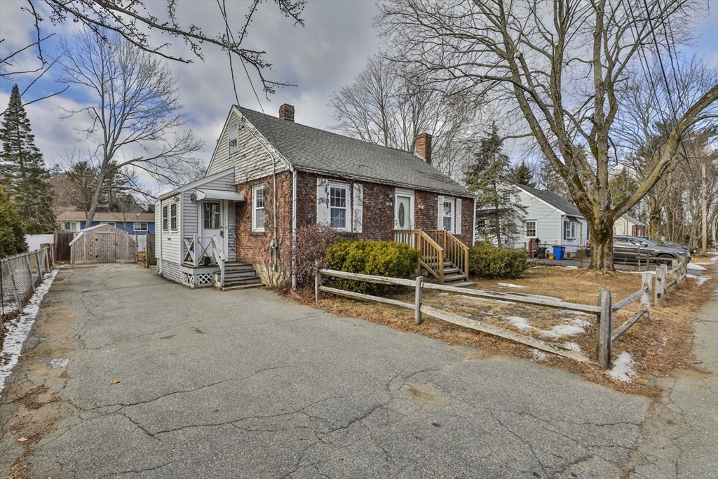 3 Veterans Lane Stoneham, MA 02180 - Photo 35 of 41 a view of a house with a yard covered in snow
