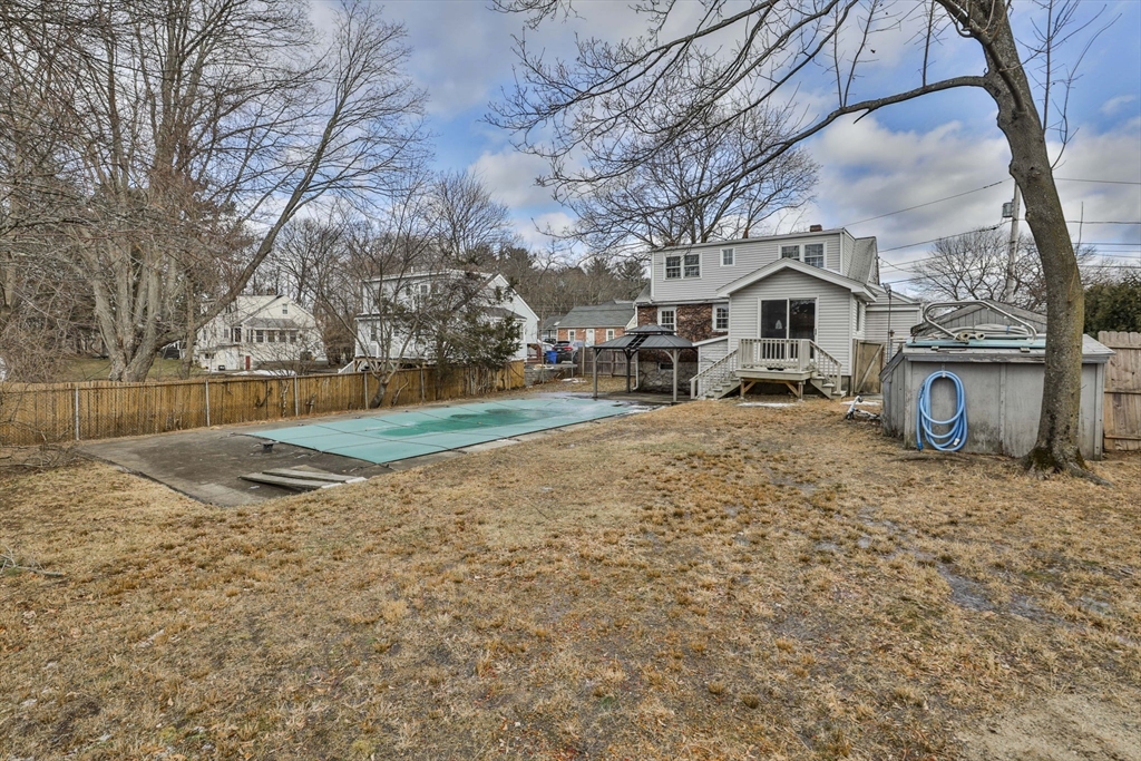 3 Veterans Lane Stoneham, MA 02180 - Photo 37 of 41 a view of a white house next to a yard with a large tree