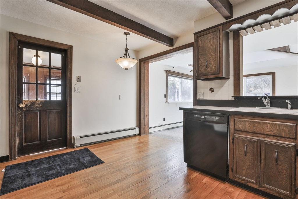 3 Veterans Lane Stoneham, MA 02180 - Photo 5 of 41 a kitchen with granite countertop wooden cabinets and a black appliances