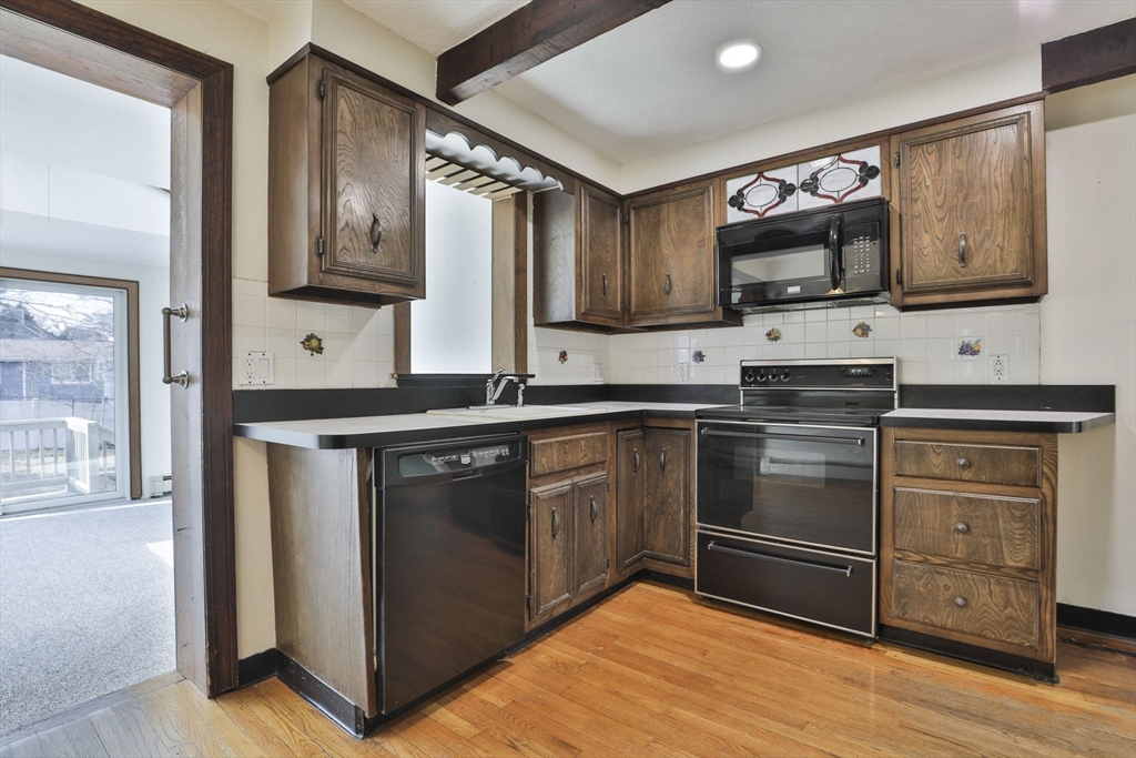 3 Veterans Lane Stoneham, MA 02180 - Photo 6 of 41 a kitchen with stainless steel appliances a stove microwave and sink