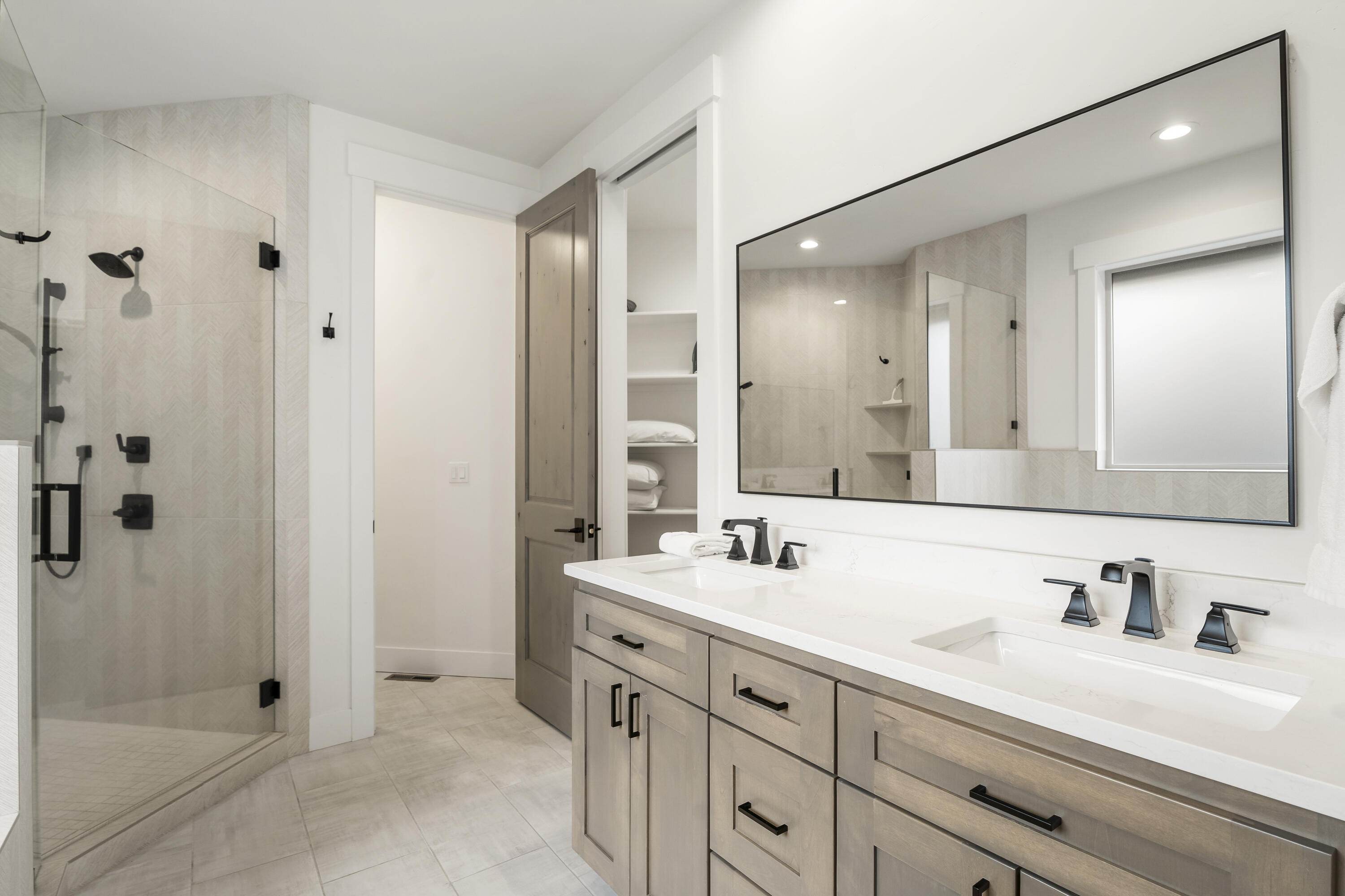 56302 Sable Rock Loop, Unit 255 Bend, OR 97707 - Photo 27 of 65 a bathroom with double sink and a mirror