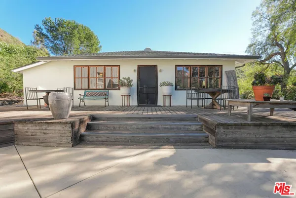 a view of house with outdoor seating