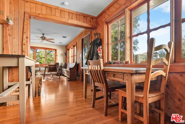 a dining room with furniture water view and large windows