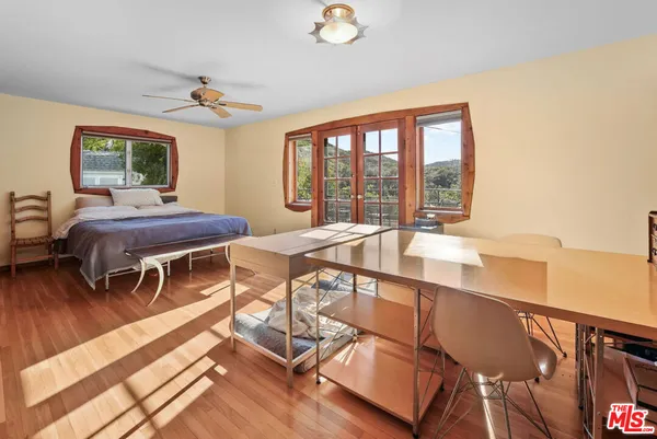 a view of a dining room with furniture a chandelier and wooden floor