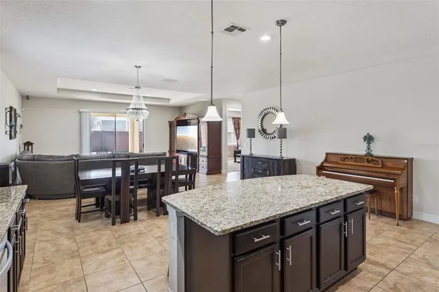 a kitchen with a table chairs and white cabinets