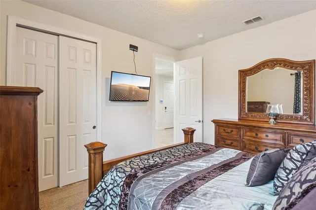 a bedroom with a bed and a dresser