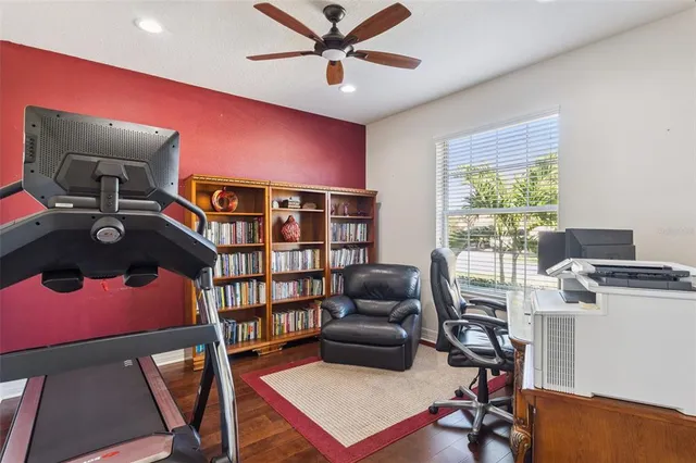 a workspace with furniture window and a ceiling fan