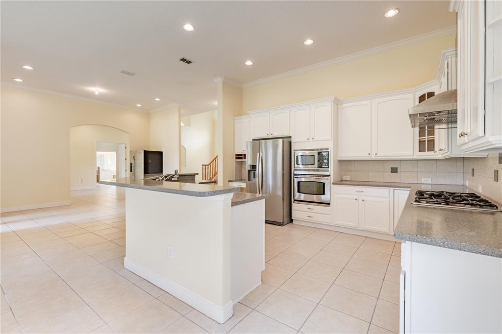 2718 Knightsbridge Road Clermont, FL 34711 - Photo 6 of 72 a kitchen with stainless steel appliances granite countertop a refrigerator and a stove