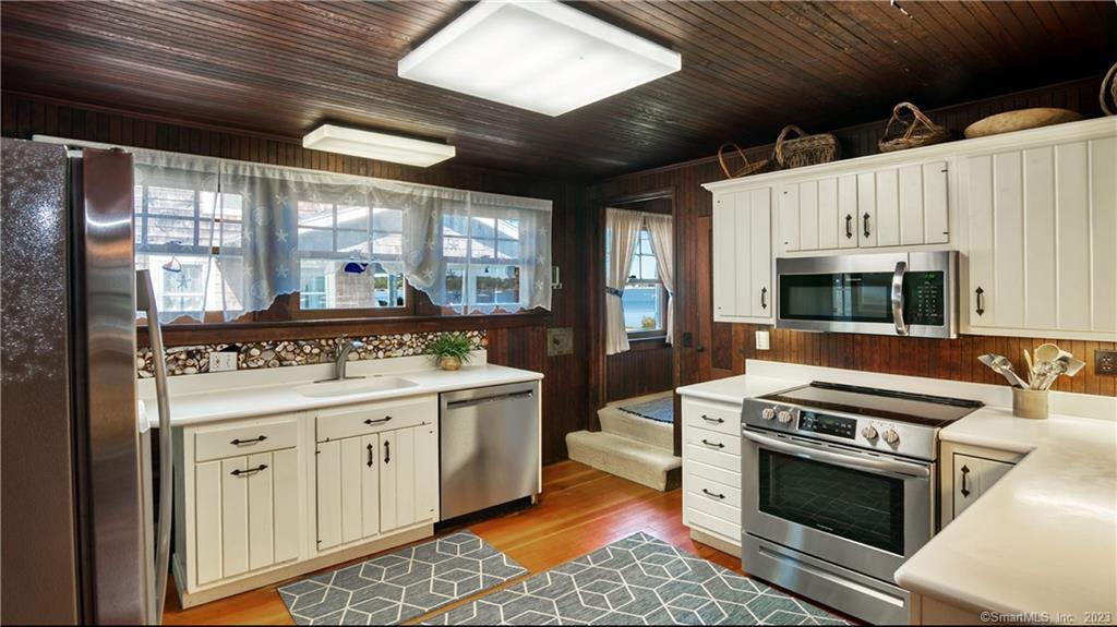 106 East Shore Avenue Groton, CT 06340 - Photo 18 of 39 a kitchen with stainless steel appliances a stove sink and cabinets