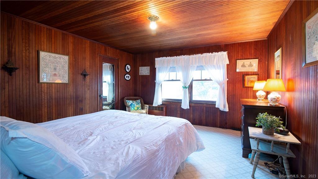 106 East Shore Avenue Groton, CT 06340 - Photo 22 of 39 a spacious bedroom with a bed and a table in it
