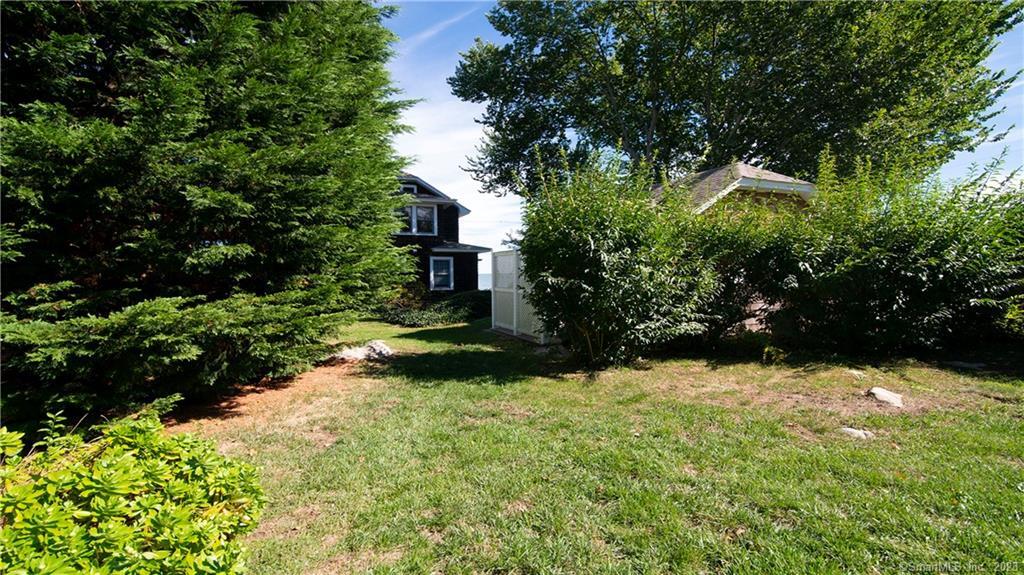 106 East Shore Avenue Groton, CT 06340 - Photo 25 of 39 a view of a yard with yellow house