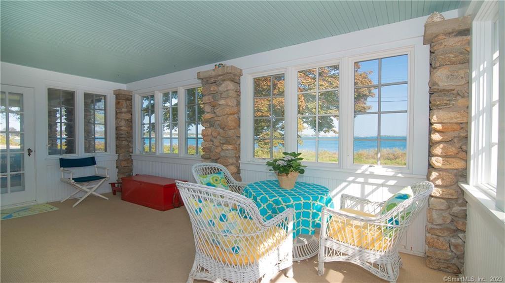 106 East Shore Avenue Groton, CT 06340 - Photo 7 of 39 a living room filled with furniture and floor to ceiling windows