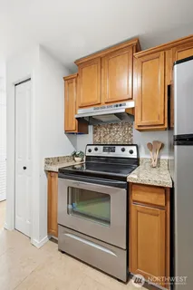 a stove top oven sitting inside of a kitchen