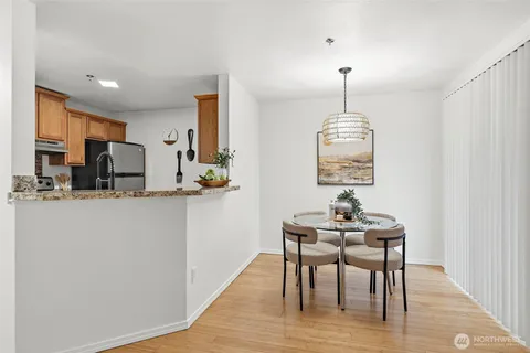 a dining room with furniture a chandelier and wooden floor