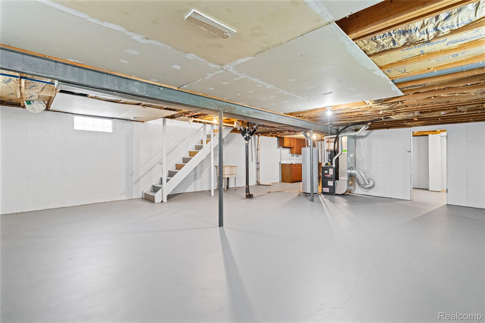3710 Branch Road Flint, MI 48506 - Photo 31 of 46 Spacious unfinished basement featuring painted concrete flooring, white painted walls, and an exposed ceiling