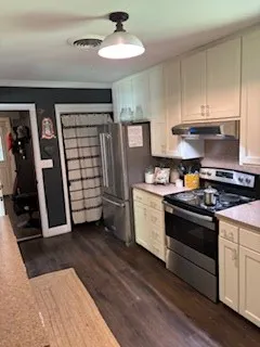 a kitchen with stainless steel appliances granite countertop a stove and a refrigerator
